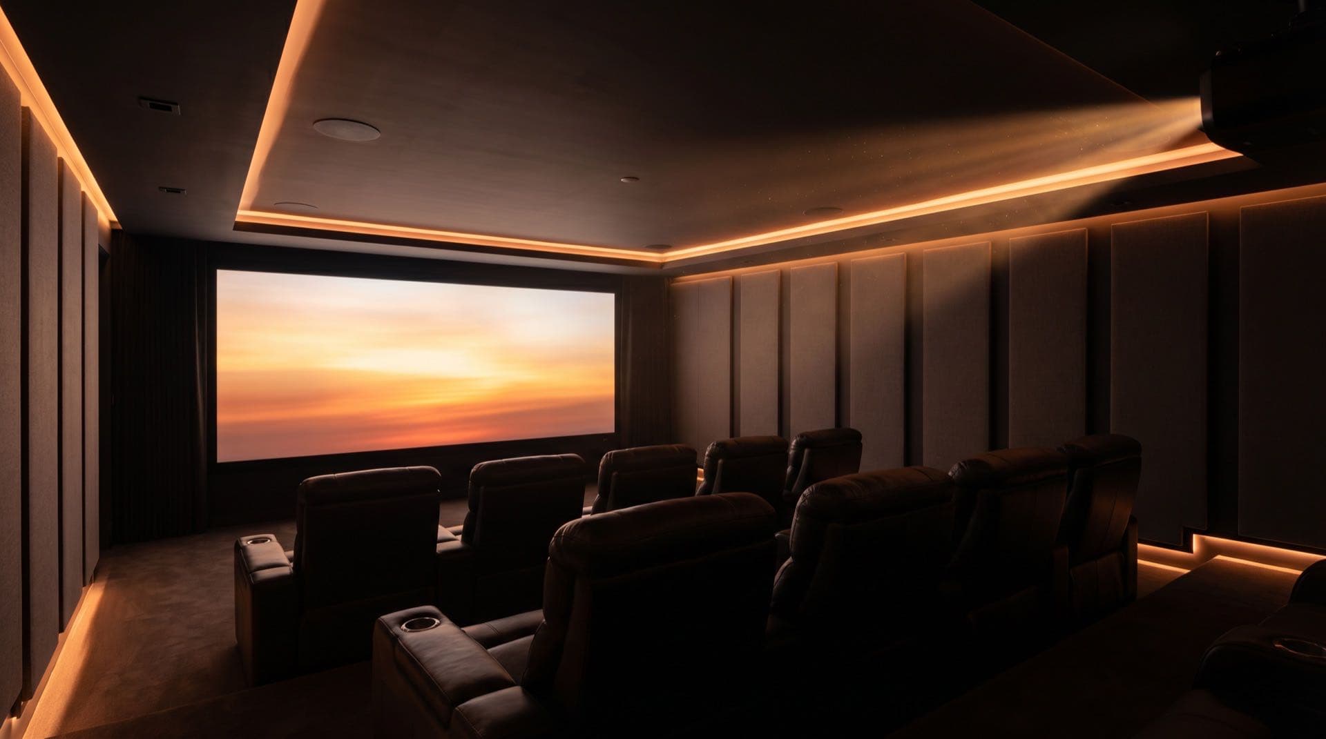 Cinematic home theater install with warm amber screen glow, plush leather recliners, and integrated lighting, Iron Lion A.V.